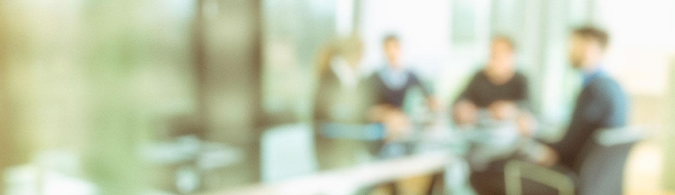 blurred people sitting at conference table